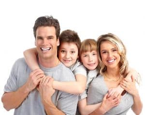 a family of four smiles