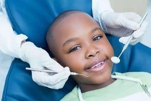 a young boy smiles while at a dentist appointment