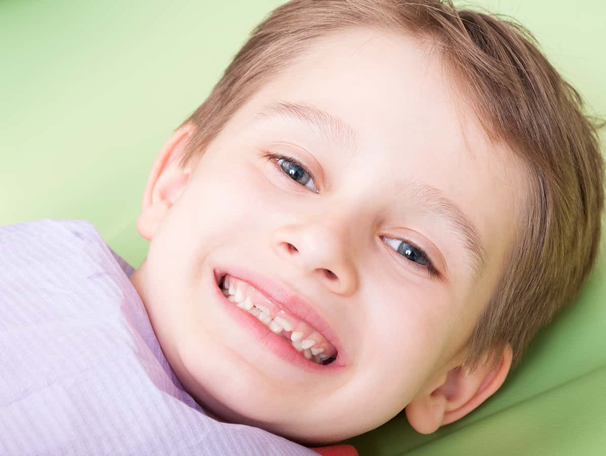 young white boy smiling in dental chair